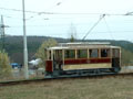 Křižíkova osmnáctka ve smyčce Bolevec. V pozadí probíhá slavsnostní otevření železniční zastávky Plzeň - Bolevec - 23. 3. 2004
